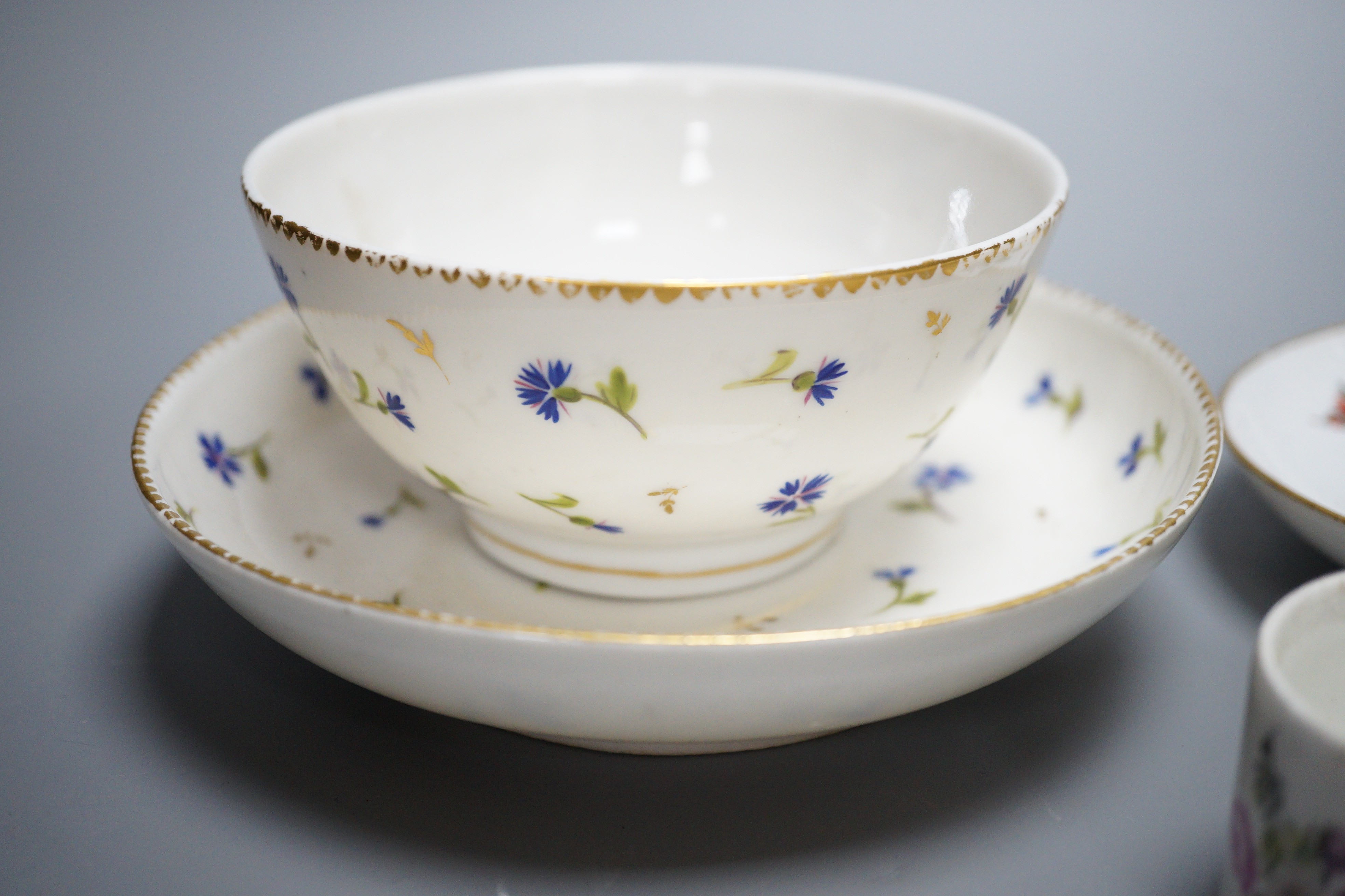 A rare Nyon porcelain slop bowl and saucer, a Meissen saucer and cylindrical pot and a pair of German saucers, red anchor marks